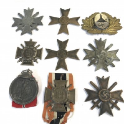 A collection of German II world war medals including a long service good conduct iron cross, a Russian Eastern Europe battle medal a rare Veterans cap badge and others.