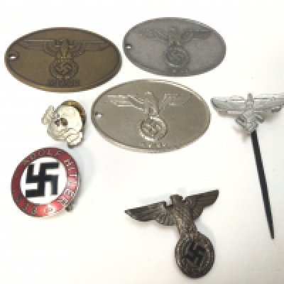A German Third Reich Political badge an Unusual tie pin replica German Gestapo ID tags one possible original and other conforming badges.