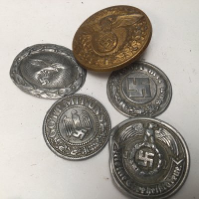 Four Aluminium pressed German Third Reich emblems including Luftwaffe and a gilt metal buckle the reverse with makers reference marks.