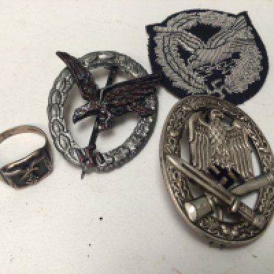 A German Third Reich Luftwaffe Radio operators badge (possibly retrospective copy) and a silver Luftwaffe ring a pressed metal Assault Badge and cloth badge (4)