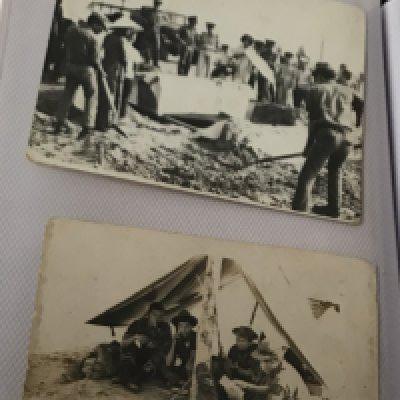 An album containing German II world war photographs bank notes Vietnam photos including military burials.