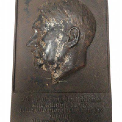 A cast metal plaque depicting Adolf Hitler and with the German inscription I believe in Germany a new beginning 32x21cm