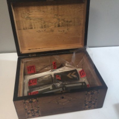 A Walnut inlaid box containing German Army shoulder straps and epaulets.