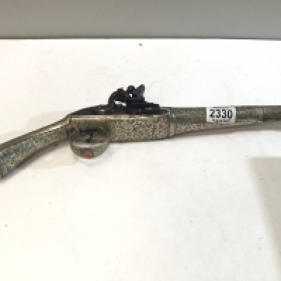 A late 18th or early 19th century Middle Eastern flintlock pistol with elaborate applied white metal decoration set with polished stone steel action. length 47cm