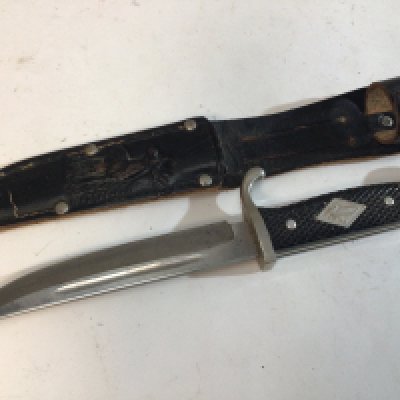 A German Scout knife the leather scabbard decorated with an image of a raised deer blade with makers name Whitey Solingen