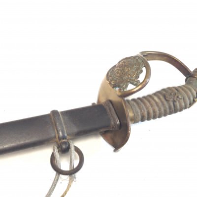 A German Imperial officers sword 1889 pattern the shagreen grip with applied lettering the brass Guard with a crest within a Laurel leaf.