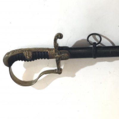 A German Third Reich officers Military dress sword most likely by WKC makers mark on blade slightly protruded a good example with dove head patterned brass lager with swastika black scabbard clean blade.