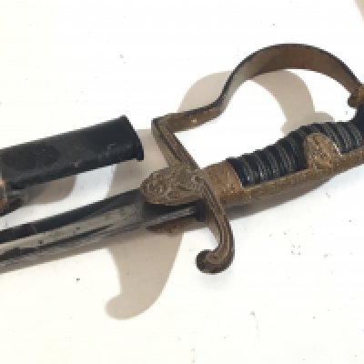 A German Third Reich Military officers dress sword with lion head pommel with red stone eyes with apllied gilt finish the steel blade with maker stamp a nice example with wear in keeping with age.