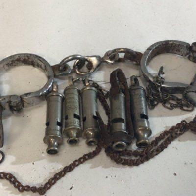 A Pair of Vintage handcuffs five vintage Whistles including Metropolitan Police and Military and a Pewter RAF tankard.