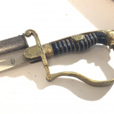 A German Third Reich officers sword with brass gilded Metal Finish with lions head pommel the blade stamped Rich A Herder Solingen.