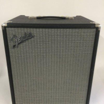 A Fender Rumble 100 amplifier with original cover.