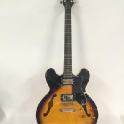 An Epiphone Dot electric guitar. Still has retail stickers attached. Comes with original retail box.