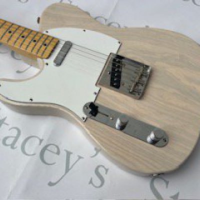 A 2004 Fender Japan Left Handed Telecaster electric guitar in excellent unplayed condition. This guitar comes with a maple neck and is finished in translucent US Blonde (Paint reference 67) which is a Fender Japan only finish. It comes with Fender Noiseless Pickups and all original parts. In near-mint condition with no real evidence of significant play-wear. No visible markings g or damage of any kind or tarnishing to brightwork. Comes with non original tweed case