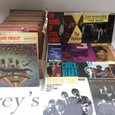 A collection of 7" singles and EPs by various artists including The Beatles, Rolling Stones, Elvis Presley and others.