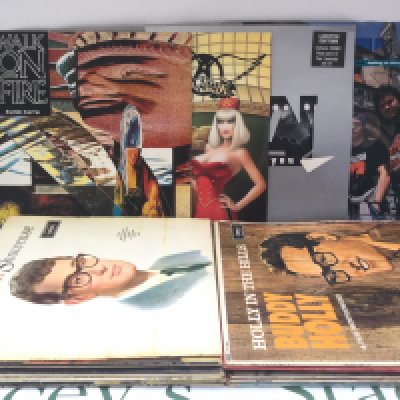 A suitcase containing LPs, 12" and 7" singles by various artists including Aerosmith, Faith No More, Sly & The Family Stone and others.