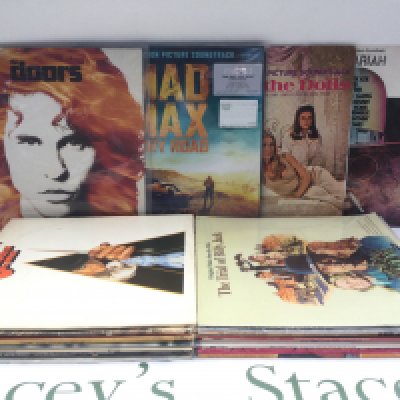 Two bags of movie soundtrack LPs including a 180g pressing of 'Mad Max - Fury Road', 'The Doors', 'American Graffiti' and others plus a Thirty Nine Steps laser disc.