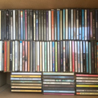Two boxes of CDs by various artists including Queen, Guns n Roses, Paul McCartney and many more.