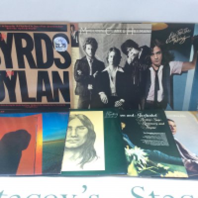 Two bags containing 23 promo copy LPs and 12" singles by various artists including The Byrds, Albert Lee, Michael Schenker Group and others.