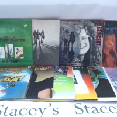 Two bags containing a collection of 23 rock LPs by various artists including Bad Company, Janis Joplin, ZZ Top and others.