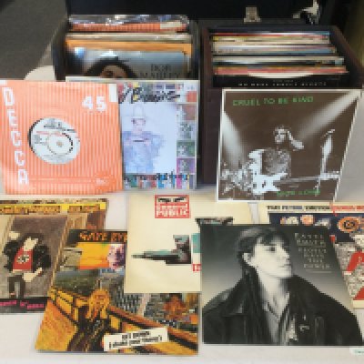 Ten record cases of 7" singles and EPs by various artists including Bob Marley, Sex Pistols, Patti Smith, Gene Vincent and many more.