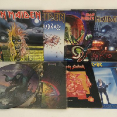 Sixteen heavy rock LPs snd 12" singles by various artists including Iron Maiden, Black Sabbath, AC/DC and others.