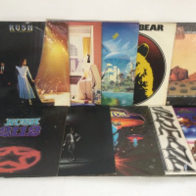 Two bags containing 20 rock LPs by various artists including Rush, Boston, Santana and others.