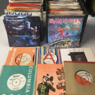 Ten record cases of 7" singles and EPs by various artists including The Beatles, Blur, The Jam, Black Sabbath and many more.