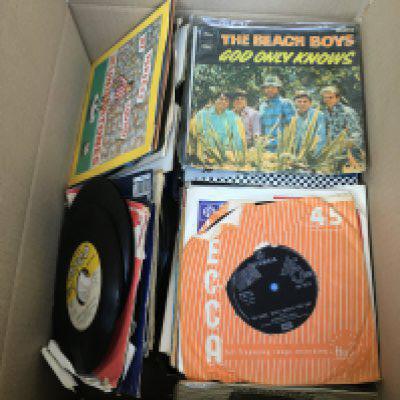 A box of 7" singles and EPs by various artists including The Beatles, Depeche Mode, The Undertones, Aztec Camera and many more.