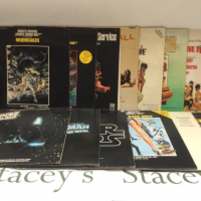 Thirteen James Bond movie soundtrack LPs.