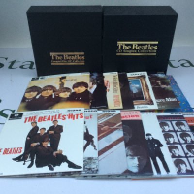 Two Beatles boxed CD collections comprising the singles and the EPs (2).