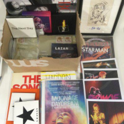 A collection of David Bowie ephemera comprising photographs, books, CDs, trading cards, stamps etc.