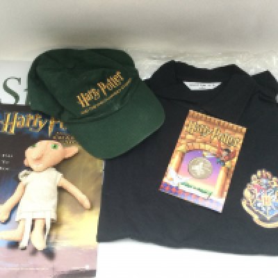 A collection of Harry Potter related items comprising a carded Dobby figure which was only available at the premiere party, coin, cap and polo shirt.