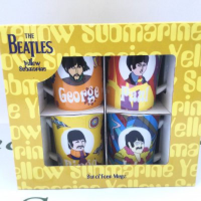 A boxed set of four Coalport Yellow Submarine mugs.