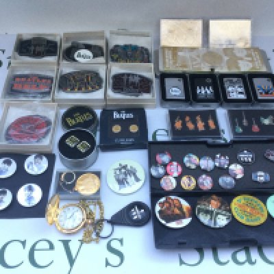 A collection of Beatles memorabilia comprising two 23kt gold trading cards, four zippo lighters, various badges, belt buckles, cufflinks etc.