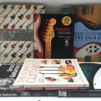 A small collection of books on guitars.