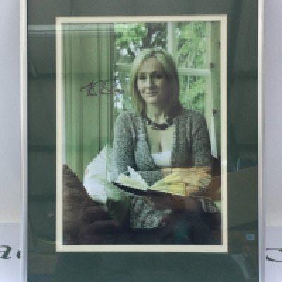 A framed and glazed signed photo of J K Rowling, approx 31cm x 41cm. with COA. Please note that we are not experts in this field and can offer no guarantees that these signatures are genuine and will not be held responsible should they prove otherwise.