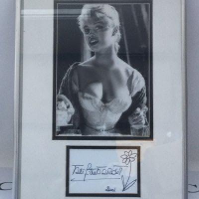 A framed and glazed signed photo display of Brigitte Bardot, approx 31cm x 41cm. No COA. Please note that we are not experts in this field and can offer no guarantees that these signatures are genuine and will not be held responsible should they prove otherwise.