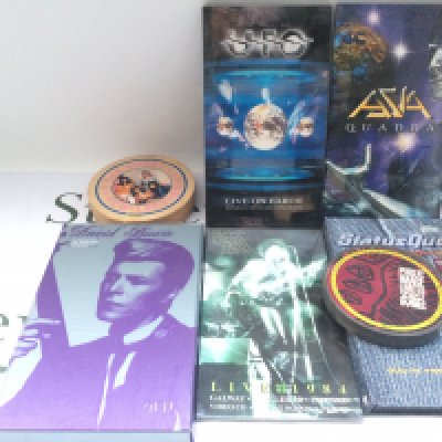 A box of CDs, DVDs, audio cassettes and VHS tapes including a David Bowie 'Sound & Vision' CD long box, PiL, UFO and many more.