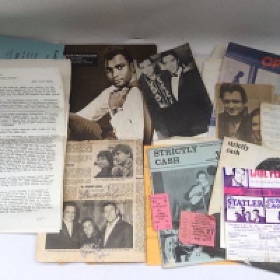 A newspaper page signed by Johnny Cash and his wife June Carter Cash plus a collection of mainly Johnny Cash memorabilia including two show tickets, fanzines etc.