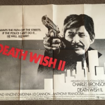 Two film posters comprising a UK quad film poster of 'Death Wish 2', folded with tears, sellotape marks, damage to corners, crude repairs approx 101cm x 76cm and A UK quad film poster for 'Assault On Precinct 13', folded with damage to top left corner, approx 101cm x 76cm.