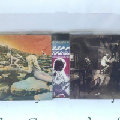 Three Led Zeppelin LPs comprising 'Houses Of The Holy', 'In Through The Out Door' and one other.