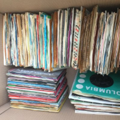 A box of 7" singles by various artists including The Beatles, Johnny Burnette, Billy Fury and many more.