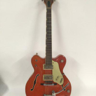 A 1963 Gretsch G6120 Chet Atkins electric guitar in the classic Western Orange finish. Needs repair to the binding in some places. Comes with original Gretsch hard carry case.