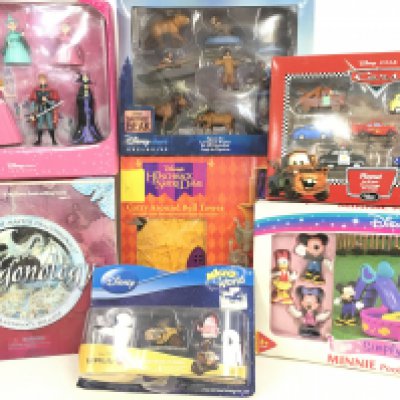 A Collection of Boxed Disney toys and A Dragonology game.
