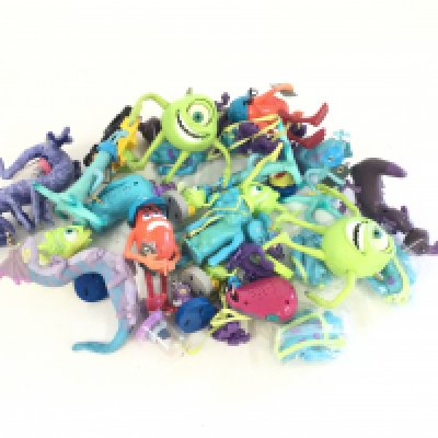 A box containing a quantity of Monsters Inc toys and figures.