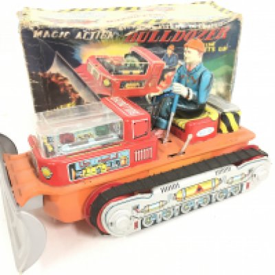 A boxed Vintage Battery Operated Magic Action Tin Bulldozer.
