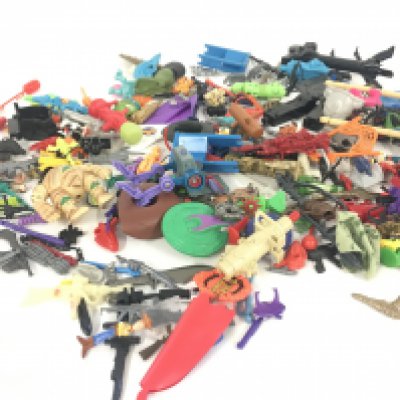 An assorted collection in excess of 100 pieces of parts and accessories from various toy lines in the 1980s and 1990s