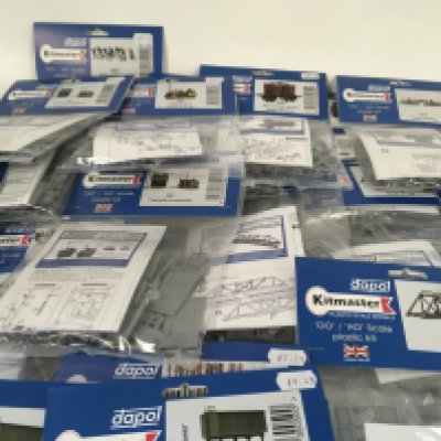 A collection of in excess of 40 new Dapol Kitmaster plastic scale model kits. 00 scale models. Includes trains and buildings and people.