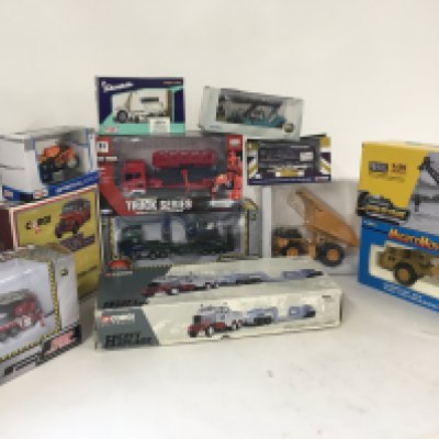 A collection of boxed diecast vehicles by various manufacturers including Corgi..Maidstone..KDW..He-Kai..Hulna etc. comprising construction vehicles..buses and motorcycles.