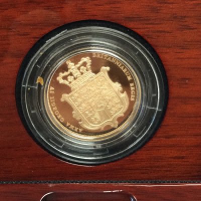 A 2025 gold proof sovereign. Postage B